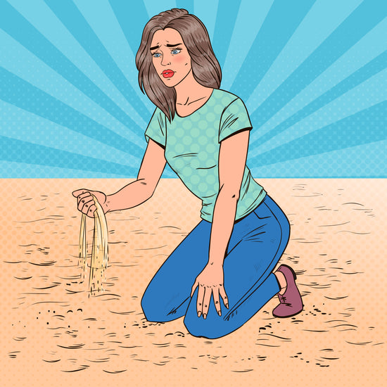 A pop art image of a women kneeling in sand on a beach .  She lets a handful of sand fall through one of her hands.  She looks sad and distressed.
