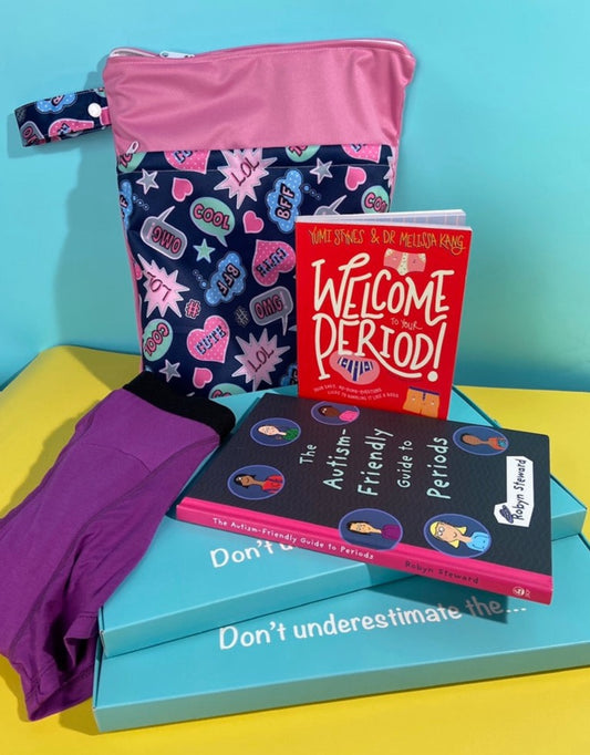 There are two horizontal flat turquoise boxes upon which the following items are displayed; a navy and pink A5 sized waterproof bag with a speech bubble pattern on it. The book 'Welcome to your Period' is standing up and the book 'The Autism Friendly Guide to Periods' is laying down in front. There is a pair of purple 'Popsicle' boyshorts to the front left of the box. The background in turquoise and yellow.